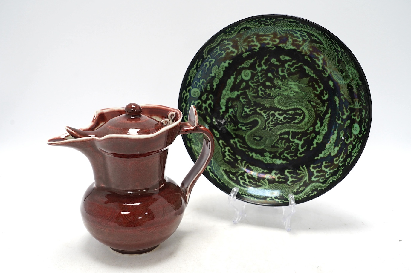 A Chinese famille noire ‘dragon’ dish, 22.5cm diameter, and a Sang de boeuf glaze monk’s cap ewer, Condition - good